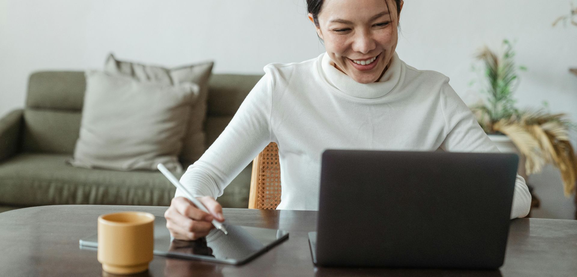 Woman working at home and making video call on laptop