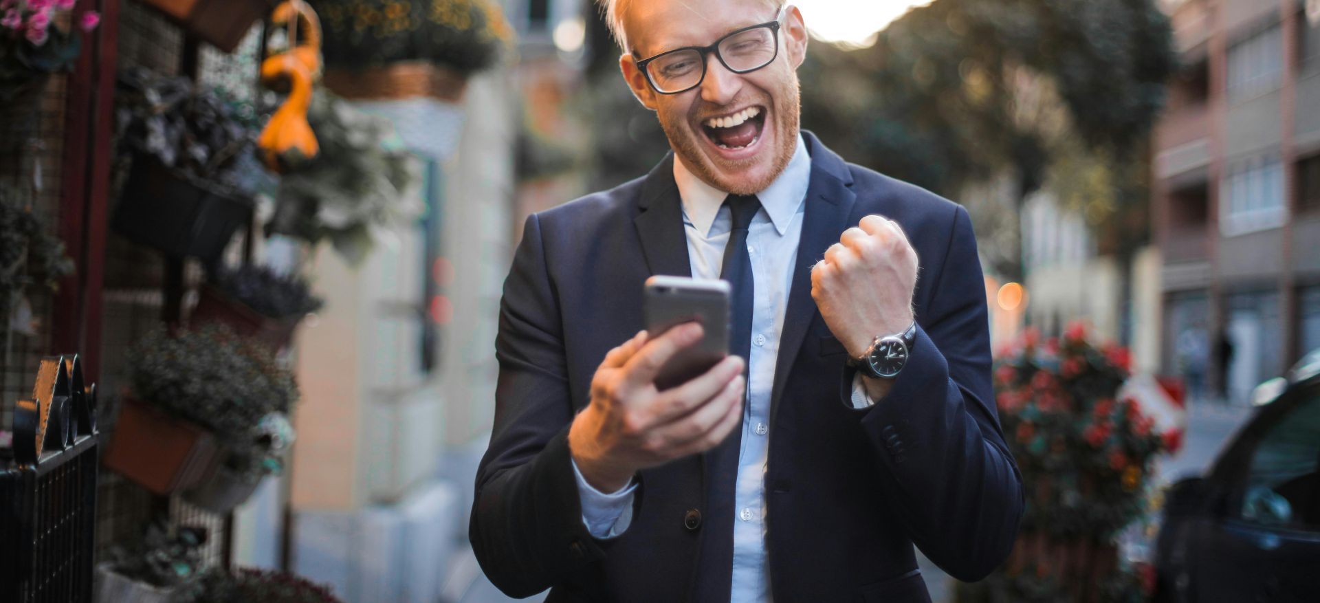 Man in Black Suit Jacket Received A Good News